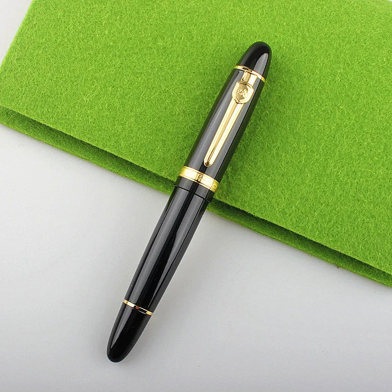 Metal ball pen with pearl beads, black body and silver clip, lying on a desk