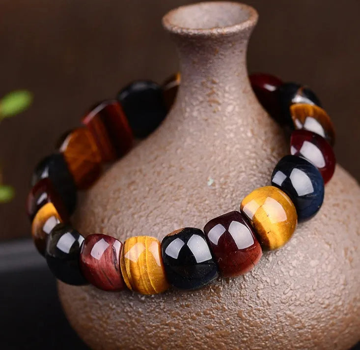 Natural tiger eye stone bracelet with round 14x10mm beads in red colour on a neutral background