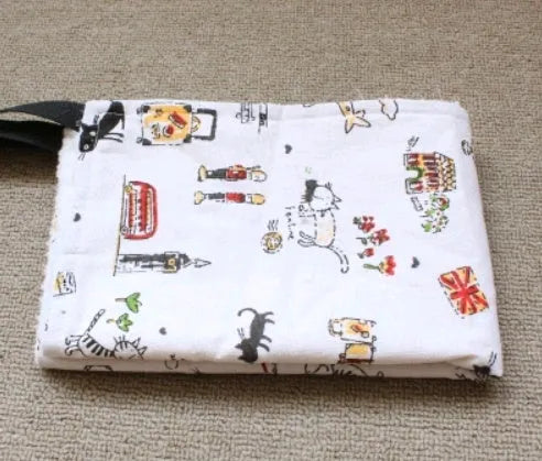 Double-sided lambskin cat hammock nest hanging in a cat cage with beige cat print pattern
