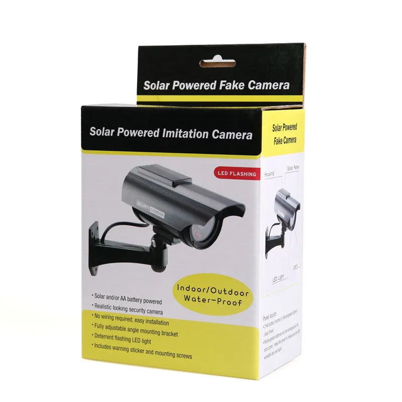 Solar powered fake security camera in black with solar panel on top and red LED light