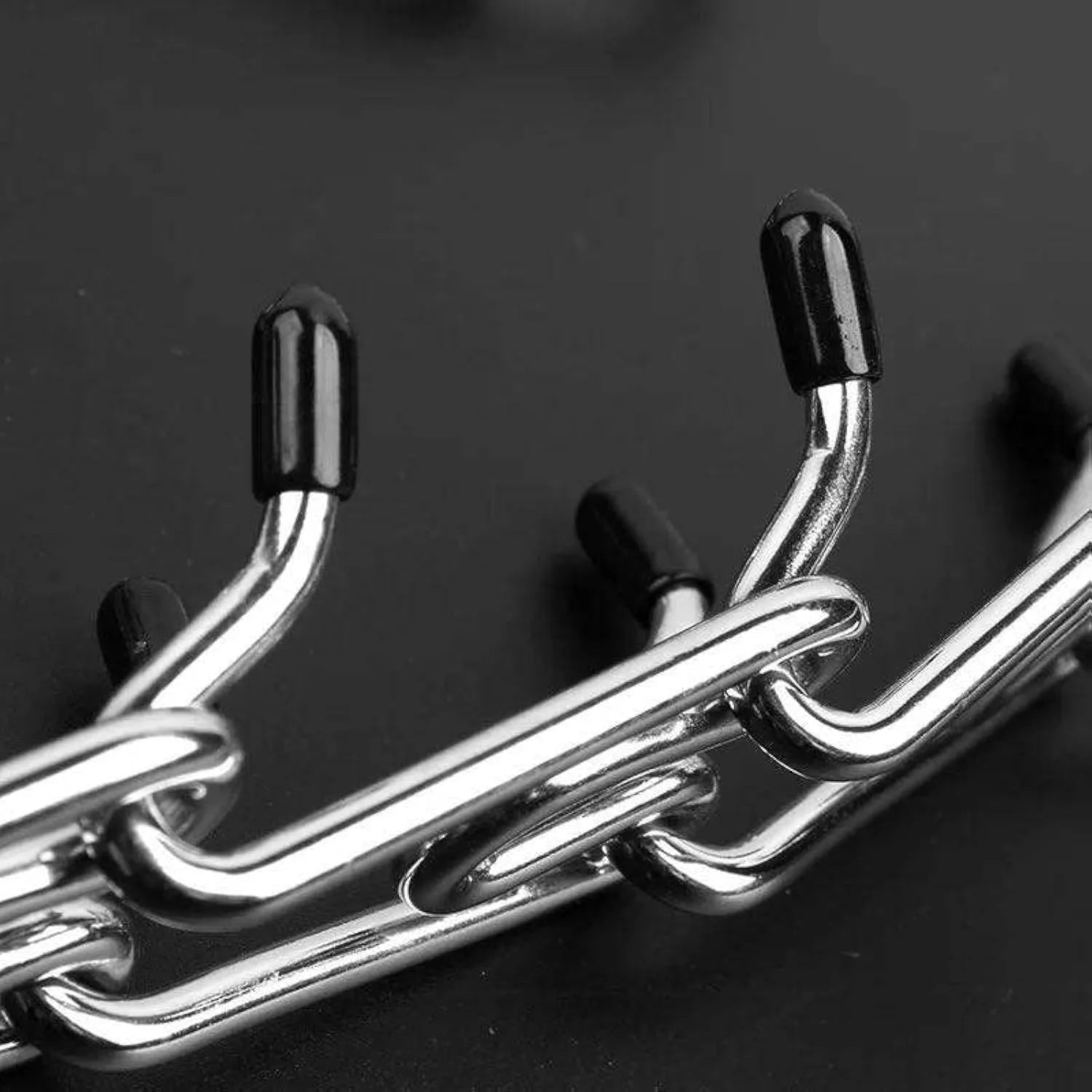 Stainless steel adjustable dog prong collar with black rubber comfort tips shown in various sizes.