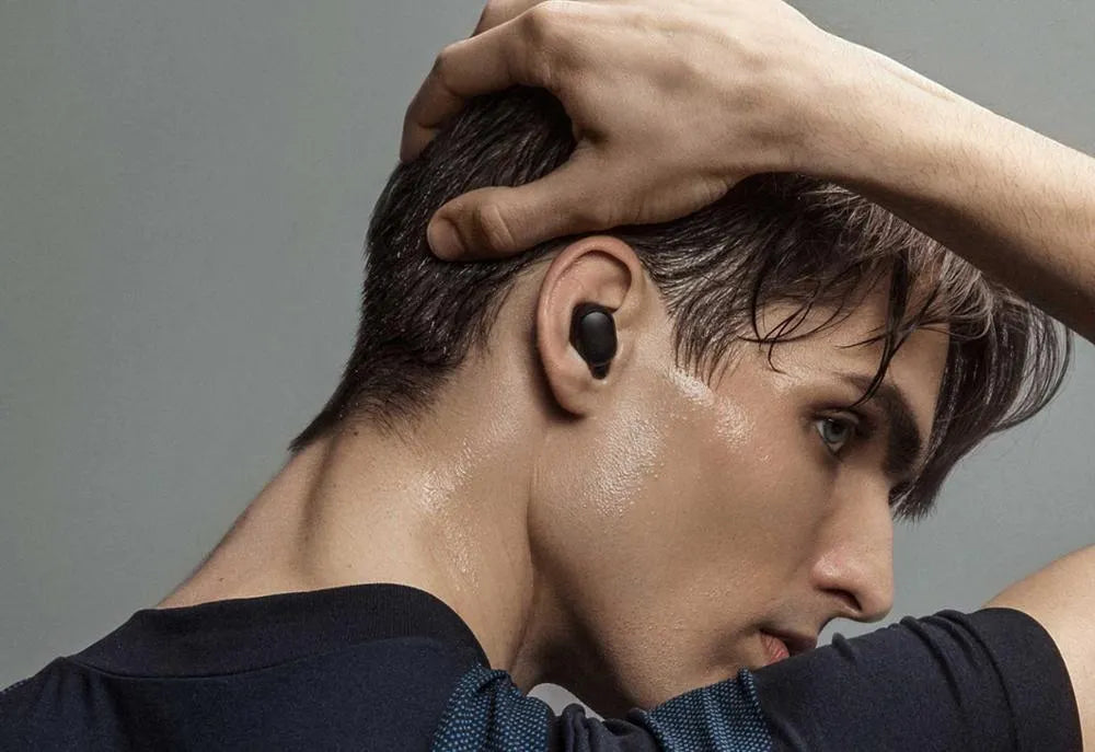 Black Redmi AirDots 2 true wireless earphones with charging case and three sizes of silicone ear tips.