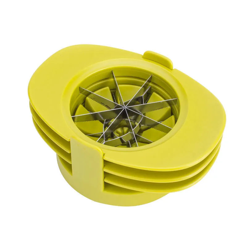 Green plastic fruit slicer for apple, tomato and mango cuts with base on a kitchen counter