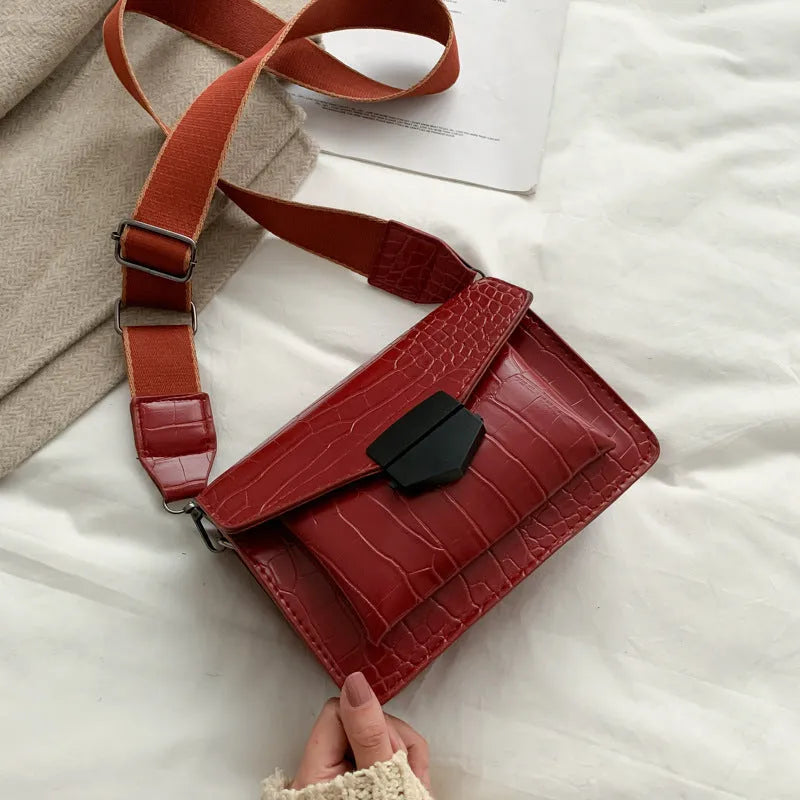 A PU fabric crossbody bag with an adjustable strap, shown in dark brown colour.
