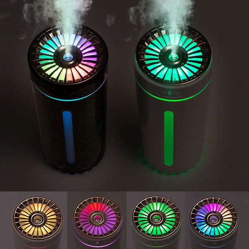 Black wireless USB car humidifier with colourful LED lights on a desktop next to a cup holder.