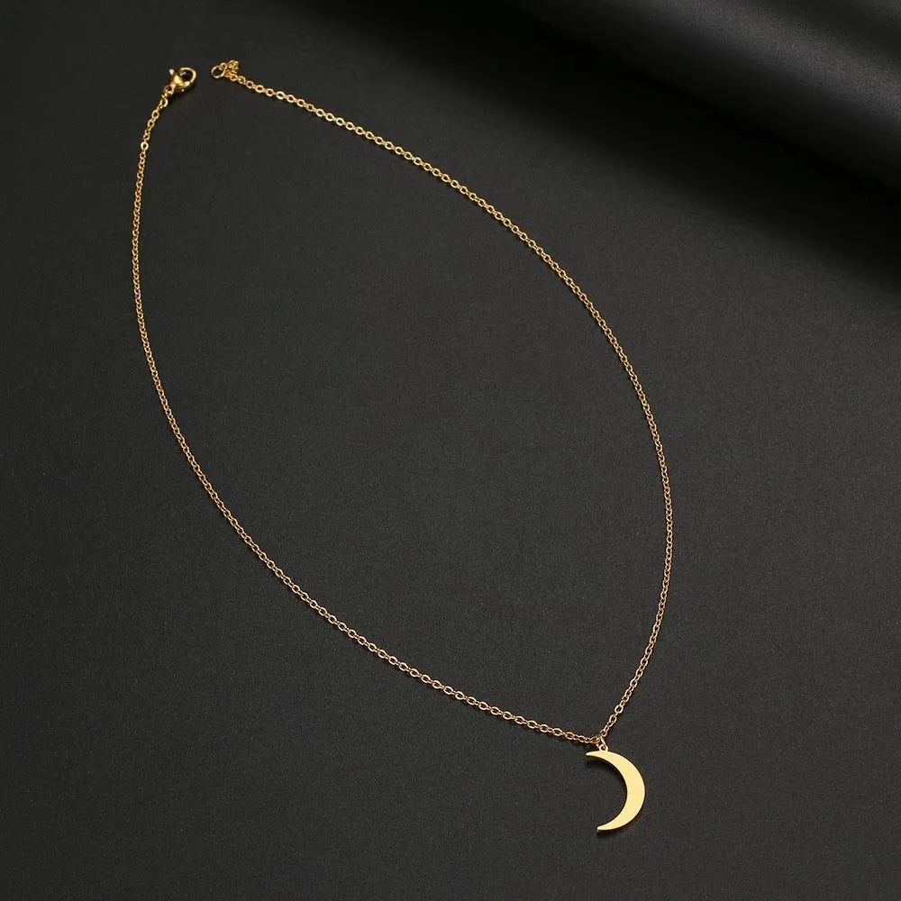 Women's stainless steel moon pendant necklace on a clavicle chain in gold or silver electroplated finish