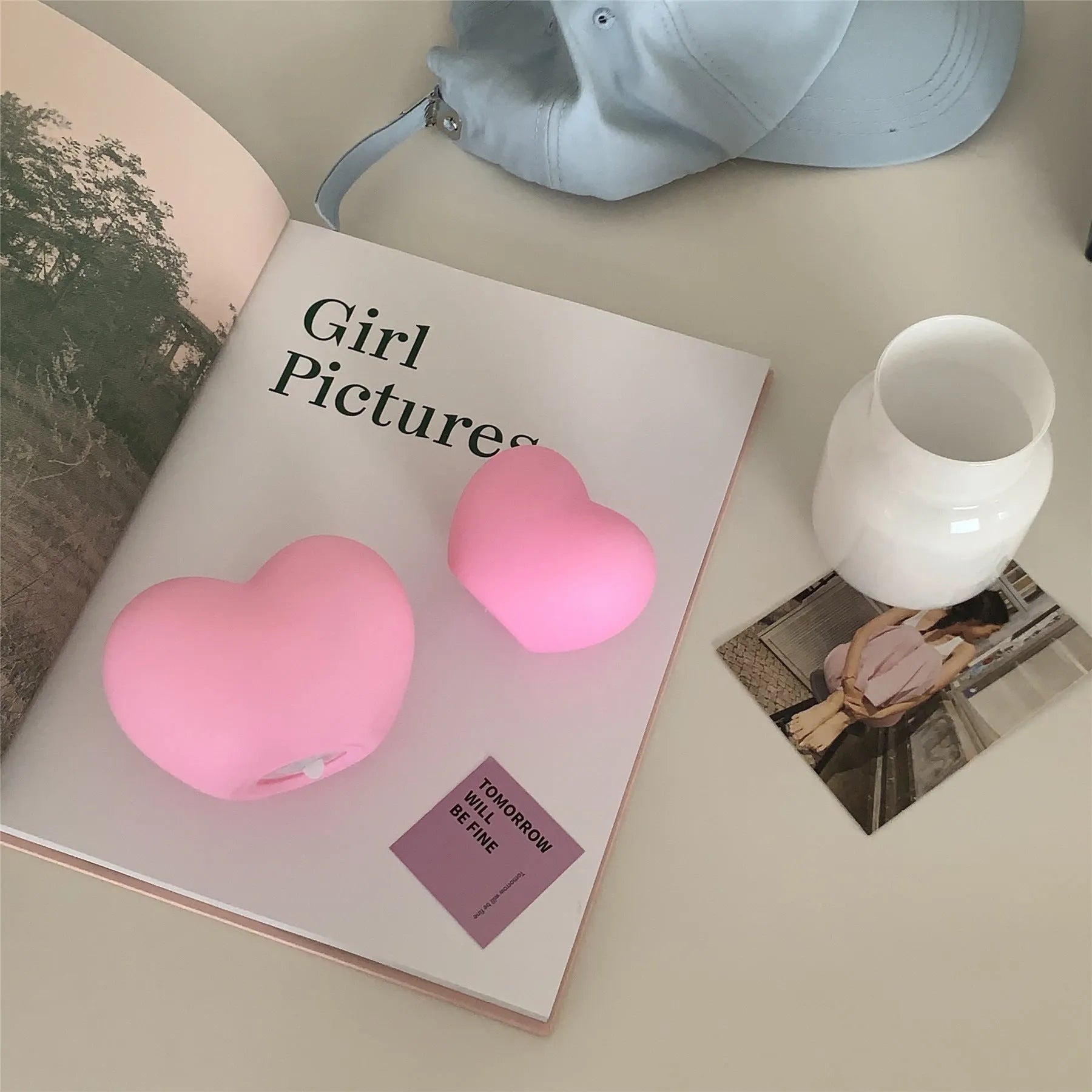 White and pink vinyl atmosphere lamp in trumpet and tuba shapes on a bedside table.