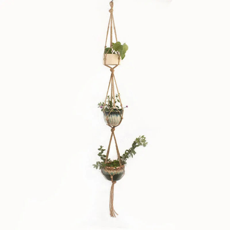Woven wire plant hanger made from cotton rope in a desktop display style holding a small potted plant.