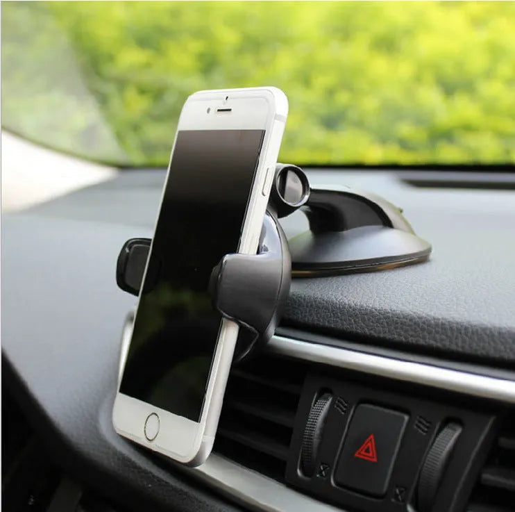 Black suction cup car phone holder holding a smartphone on car dashboard