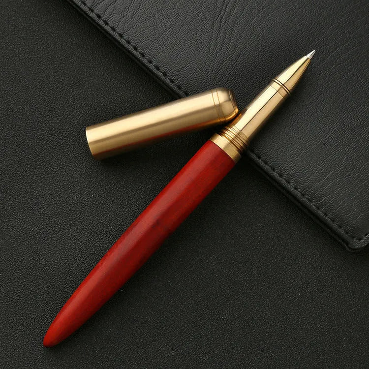 Brass and solid wood signature pen showing wood grain and metallic details.