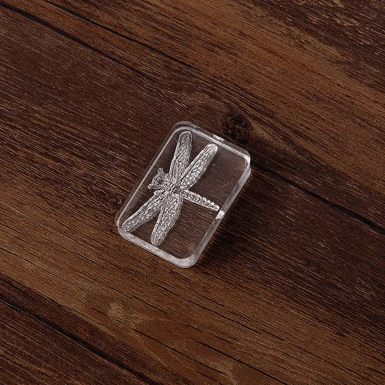 Clear acrylic hand stamp with dragonfly design and integrated silicone pad on white card