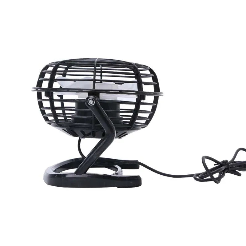 Compact black mini USB desk fan with adjustable tilt on a desk next to a laptop.