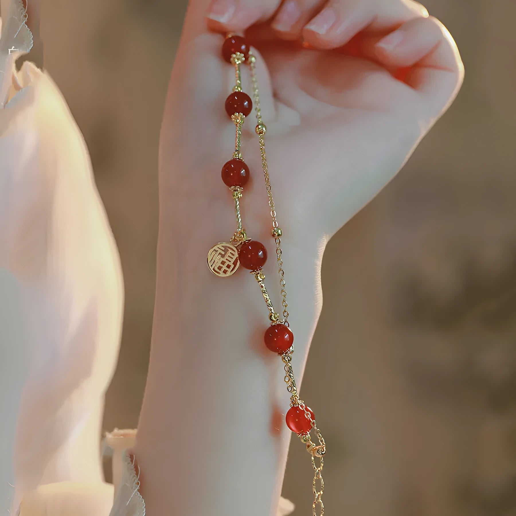 Red agate and alloy double-layer women's bracelet with Hongma lucky charm pendant on wrist