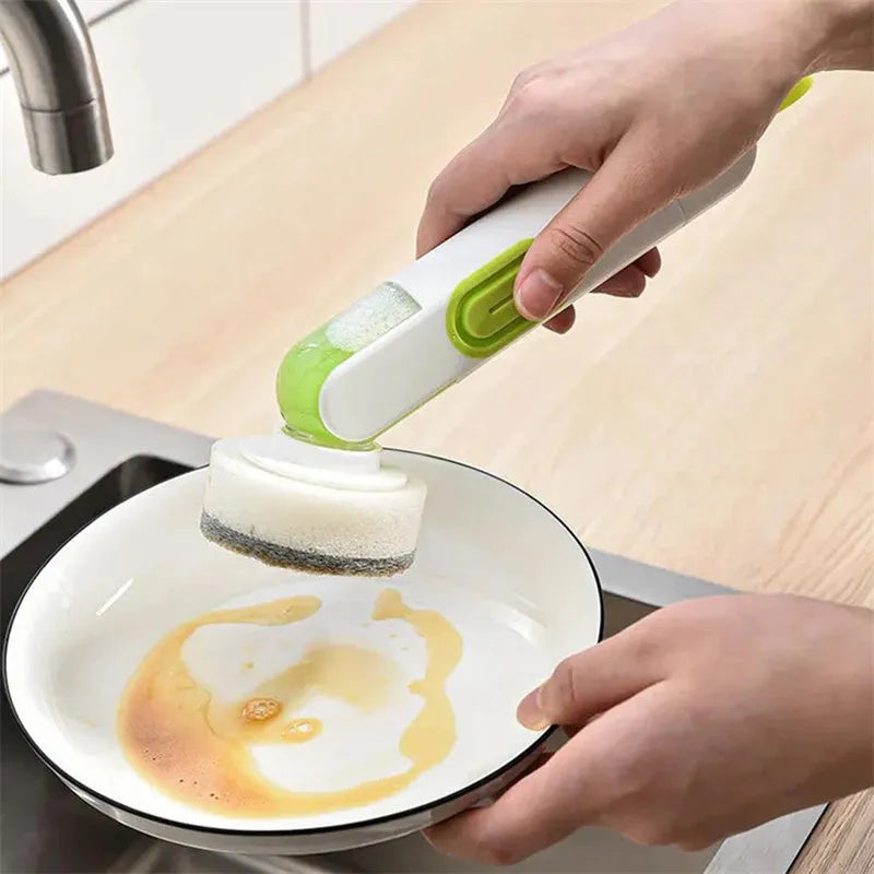 White and green liquid-filled cleaning brush with soap dispenser handle and two brush heads for kitchen cleaning