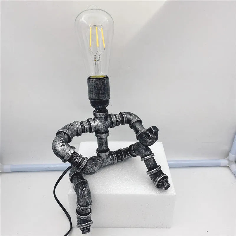 Industrial retro style water pipe robot table lamp made of iron in a vintage colour.