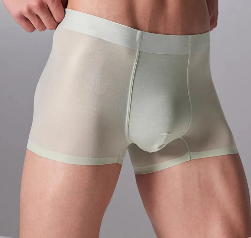 Man wearing seamless grey fitness shorts with antibacterial finish, sizes up to 3XL.