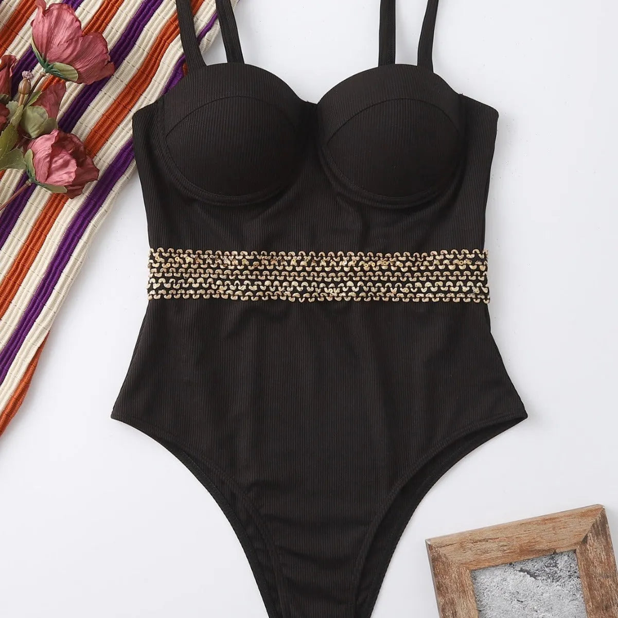 Black women's one-piece swimsuit with adjustable shoulder strap on a mannequin.