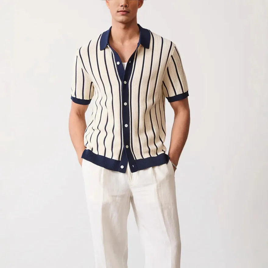 Men's white asymmetric lapel short sleeve knitted shirt laid flat.