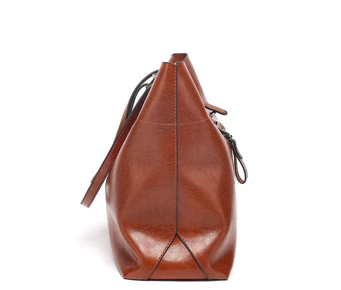 Brown waxed cowhide cross-body handbag showing front view, internal phone pocket, and adjustable leather strap.
