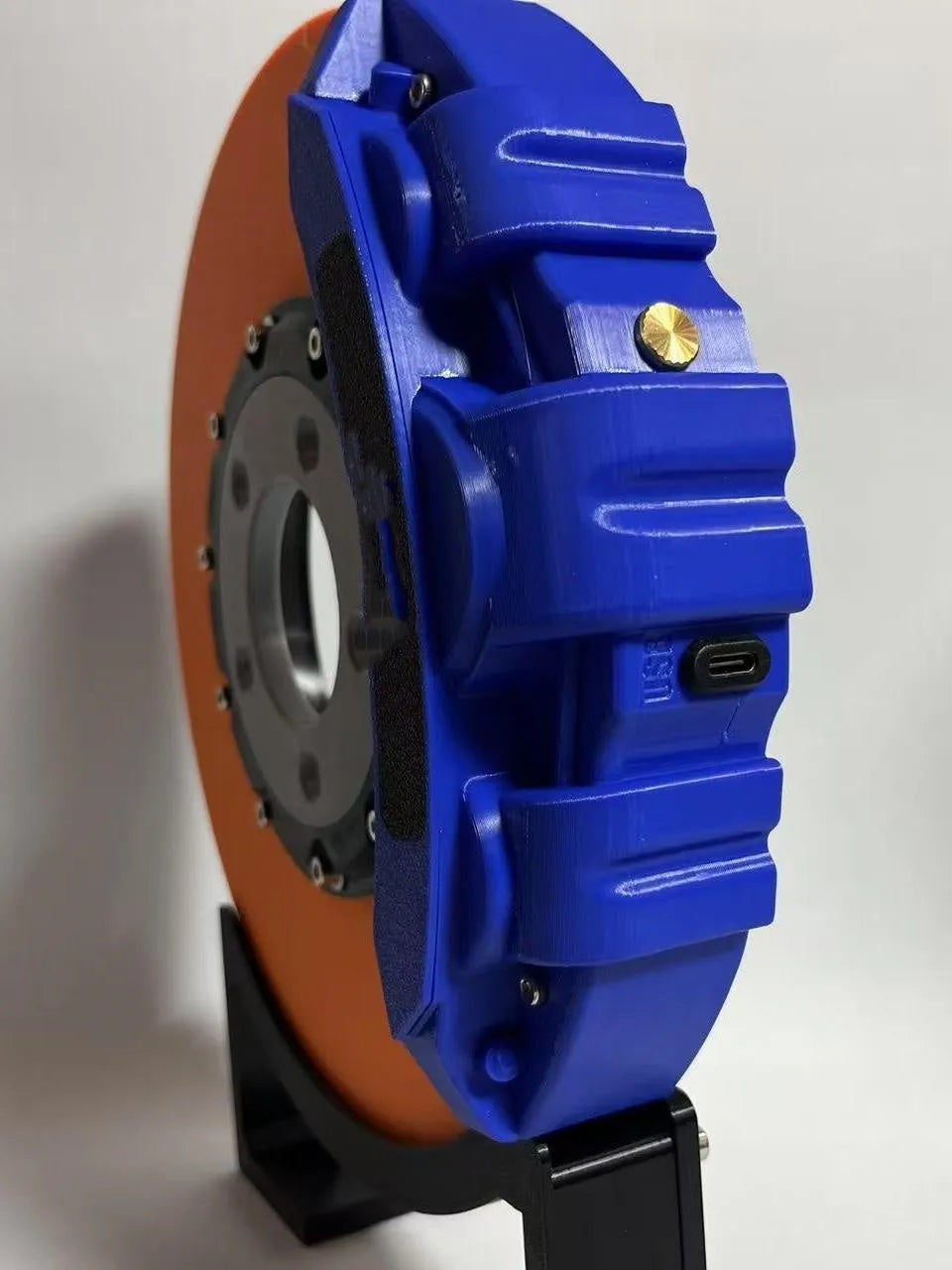 Brake disc design rechargeable LED night light with touch control in blue, red or yellow.