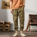 Men's cotton harem pants with tapered ankle cuffs in black colour showing loose fit and zip fly closure