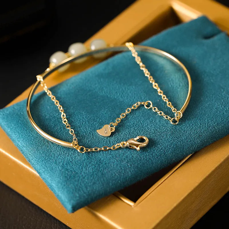 Women's Hetian jade lucky beads bracelet with gold inlay in a fake two pieces style.