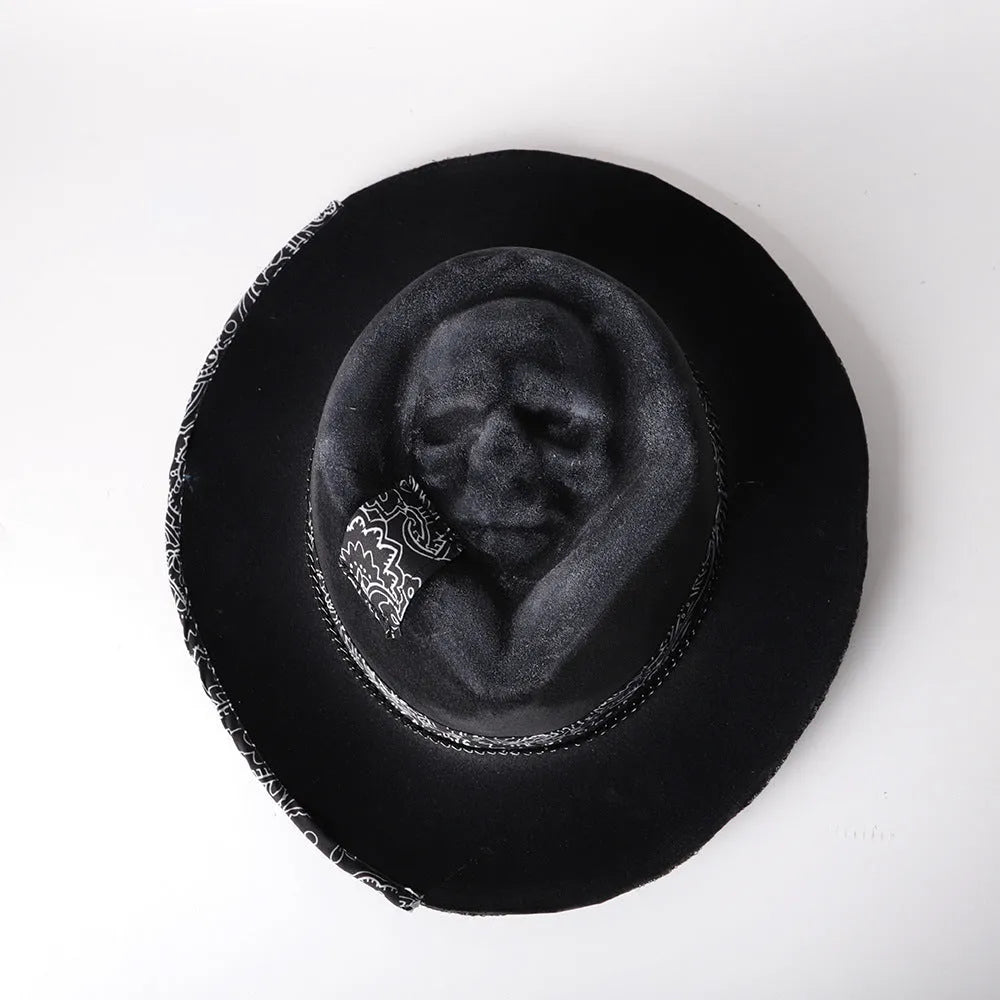Handmade grey wool felt conical hat with a black embroidered skull design on the front.