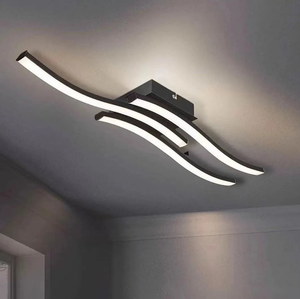 Modern minimalist black flush mount LED ceiling light with aluminium shade, shown on a white ceiling.