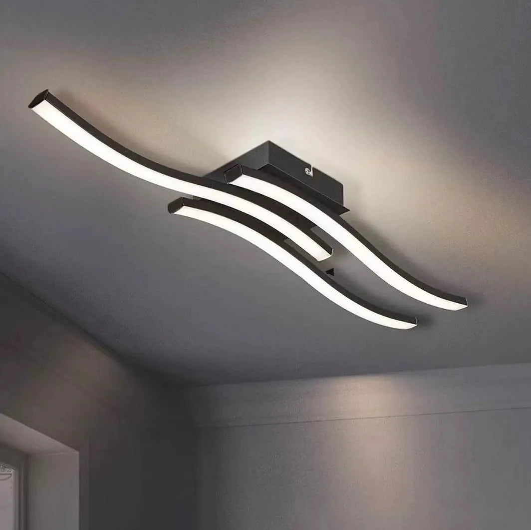 Modern minimalist black flush mount LED ceiling light with aluminium shade, shown on a white ceiling.