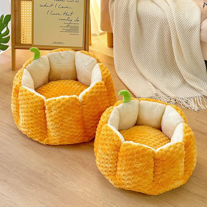 Pumpkin-shaped orange cat nest with raised sides and cotton filling in two size options