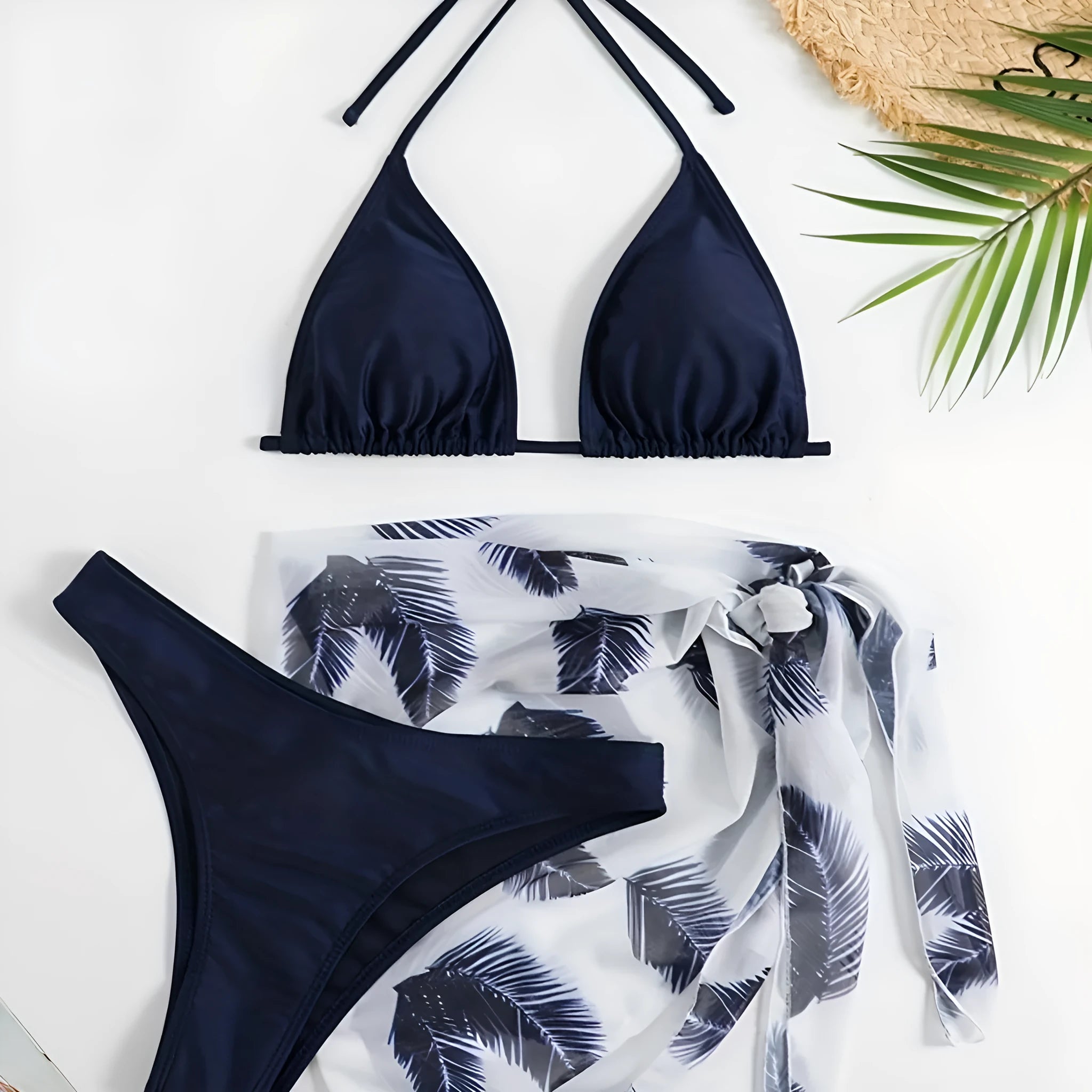 Women's orange polyester bikini set with a matching printed gauze skirt laid flat.