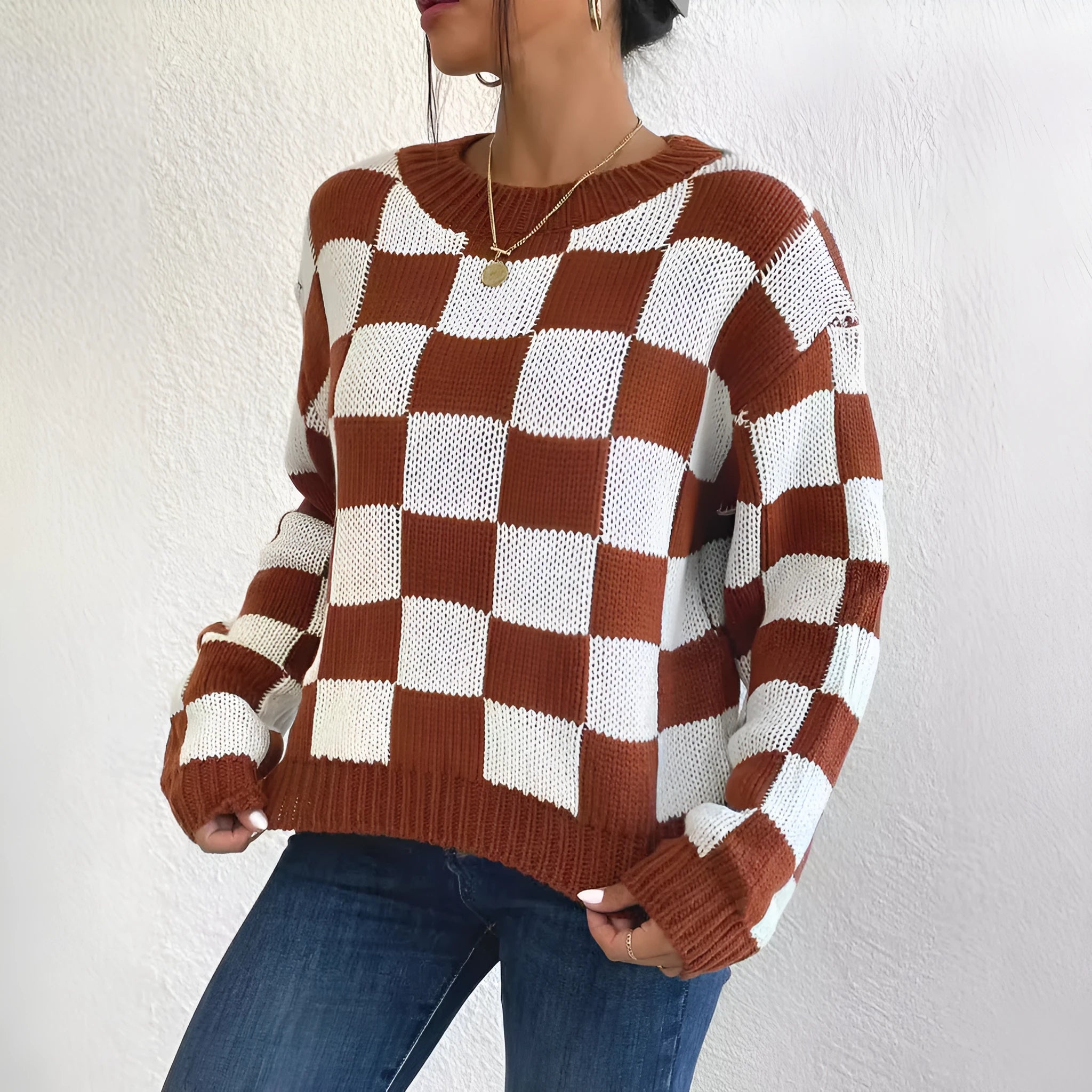 Dark brown plaid pattern acrylic pullover sweater with long sleeves and a loose round neck.