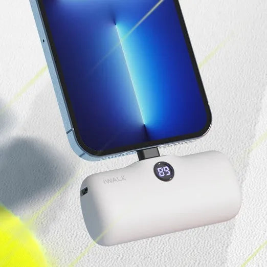 Compact cylindrical lipstick power bank in purple showing digital battery percentage display on one end.