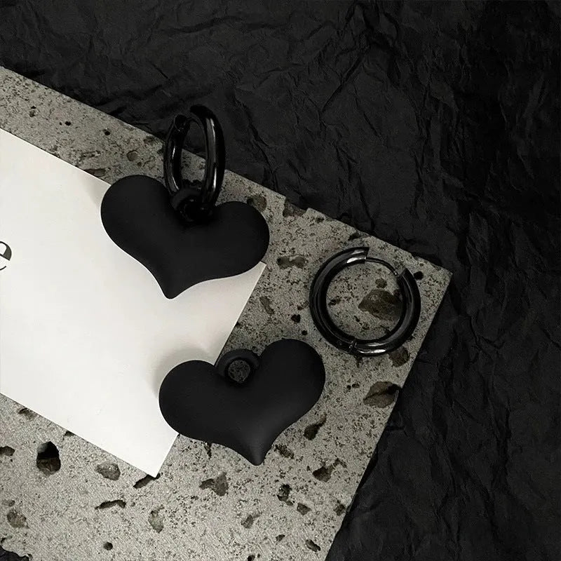 Black heart-shaped earrings with glass inlay in Korean style, shown as one pair