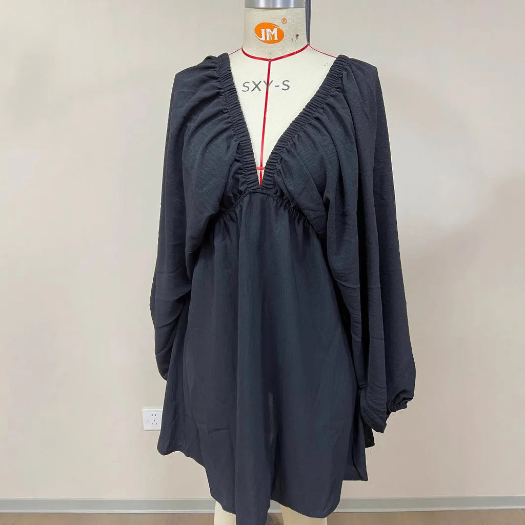 Women's apricot V-neck dress with long puff sleeves and a swing flounced skirt.