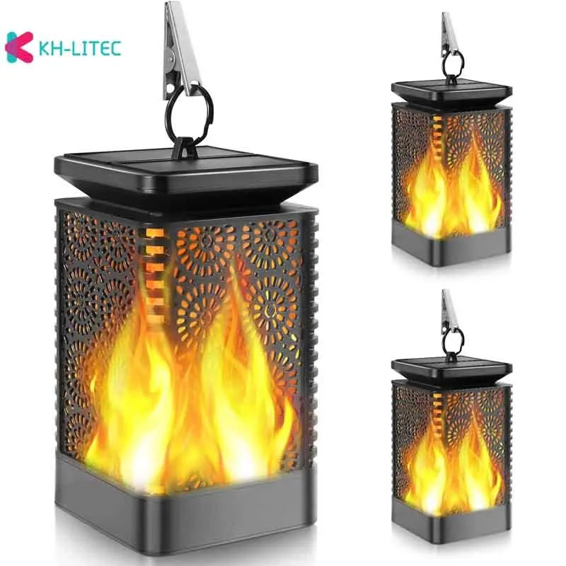 Set of four black solar-powered garden lanterns with flickering LED flame effect.