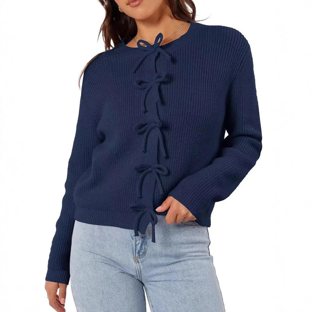 Women's long sleeve knitted cardigan with bow pattern in loose fit, available in multiple colours, shown on model