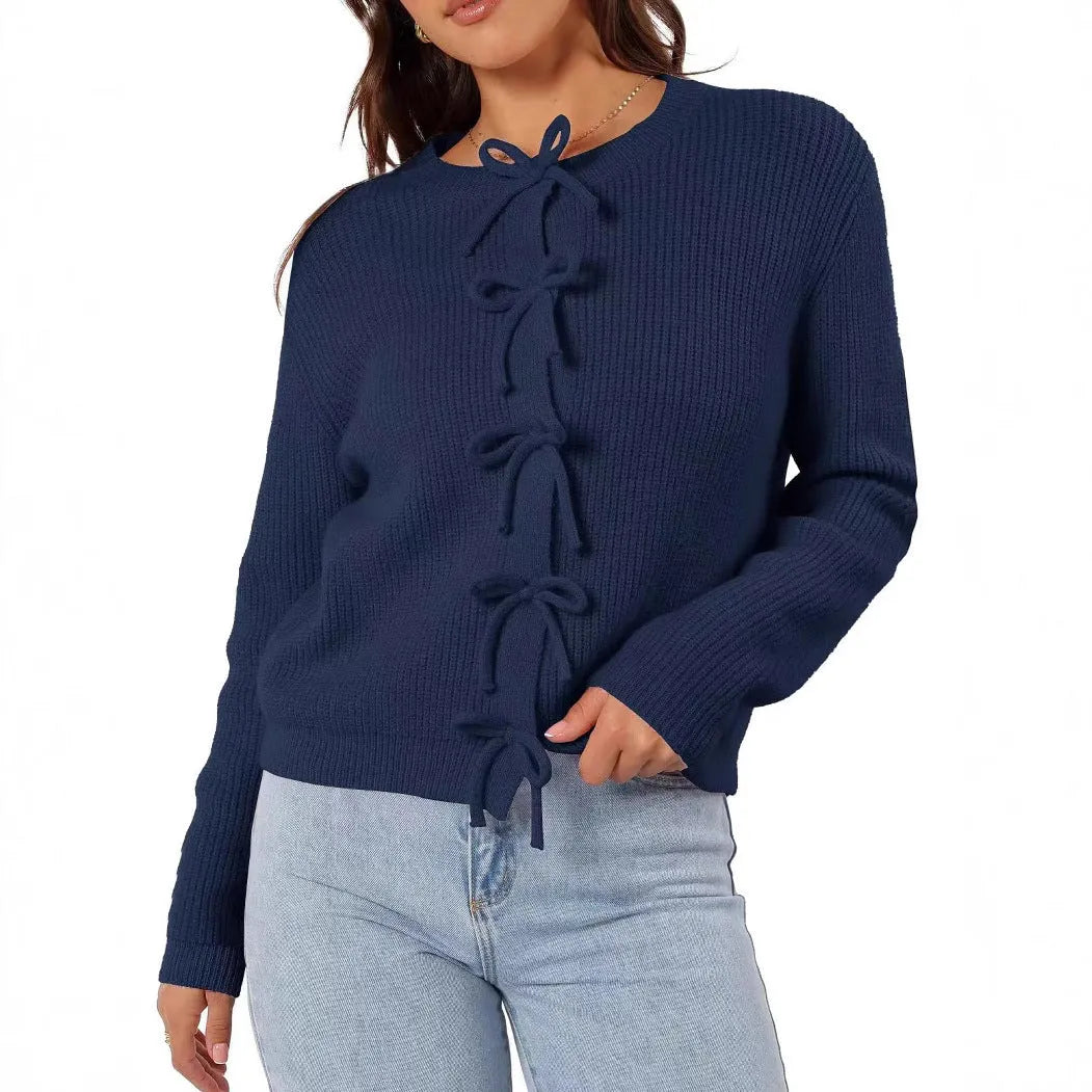 Women's long sleeve knitted cardigan with bow pattern in loose fit, available in multiple colours, shown on model