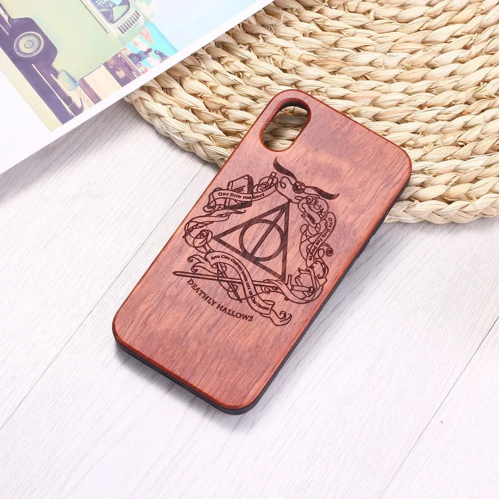 Wooden phone case with laser-carved back and black TPU frame for iPhone.