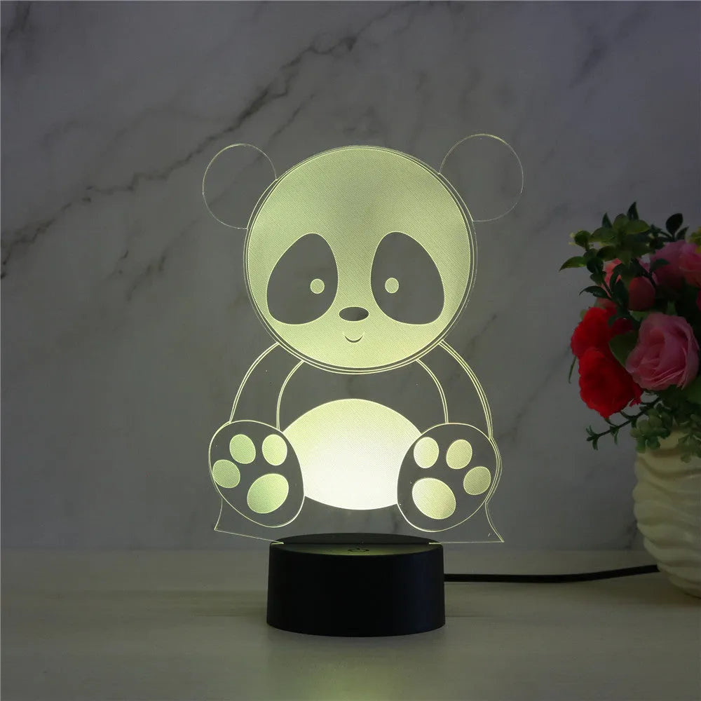 Panda-shaped acrylic night light with remote control on a table, showing multi-coloured LED illumination.