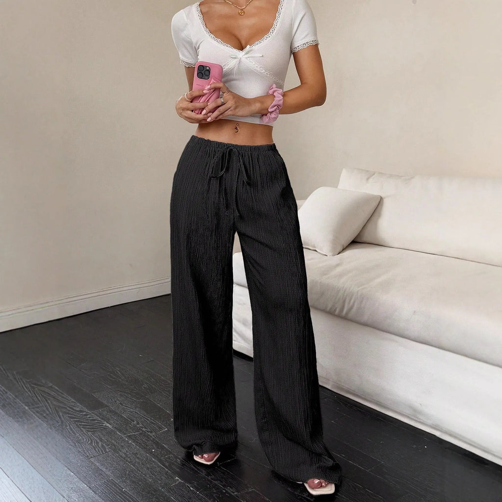 Women's black wide-leg trousers with a front lace-up waist detail on a mid-waist.