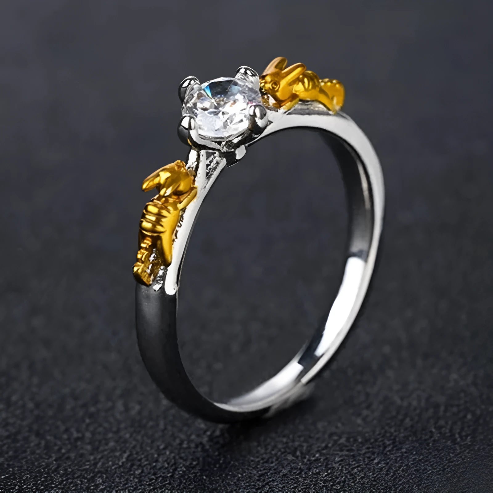 Close-up of a black gold copper ring with a detailed three-dimensional crown design on a finger.