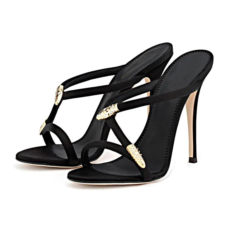 Black satin stiletto sandals with 9cm heel and decorative buckle shown on a white background