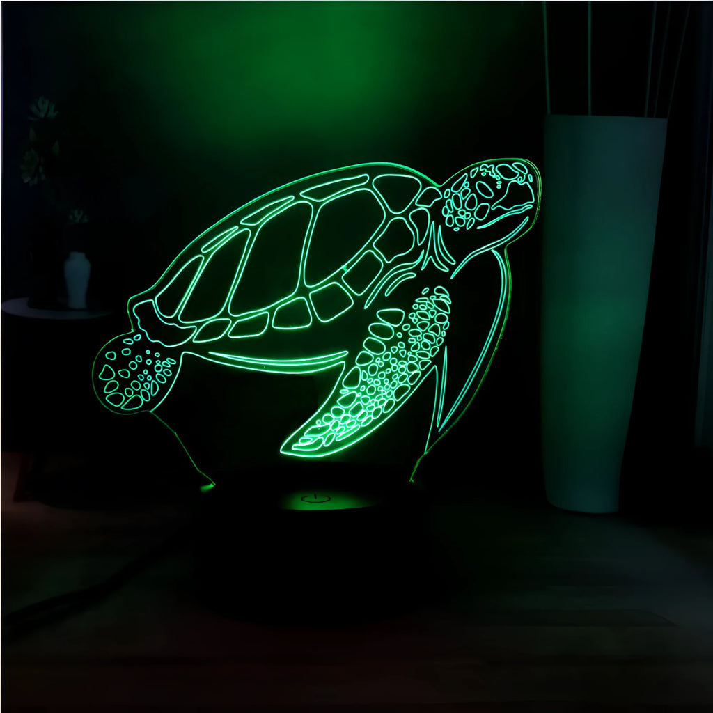 3D acrylic turtle-shaped LED night light with remote control on a bedside table.