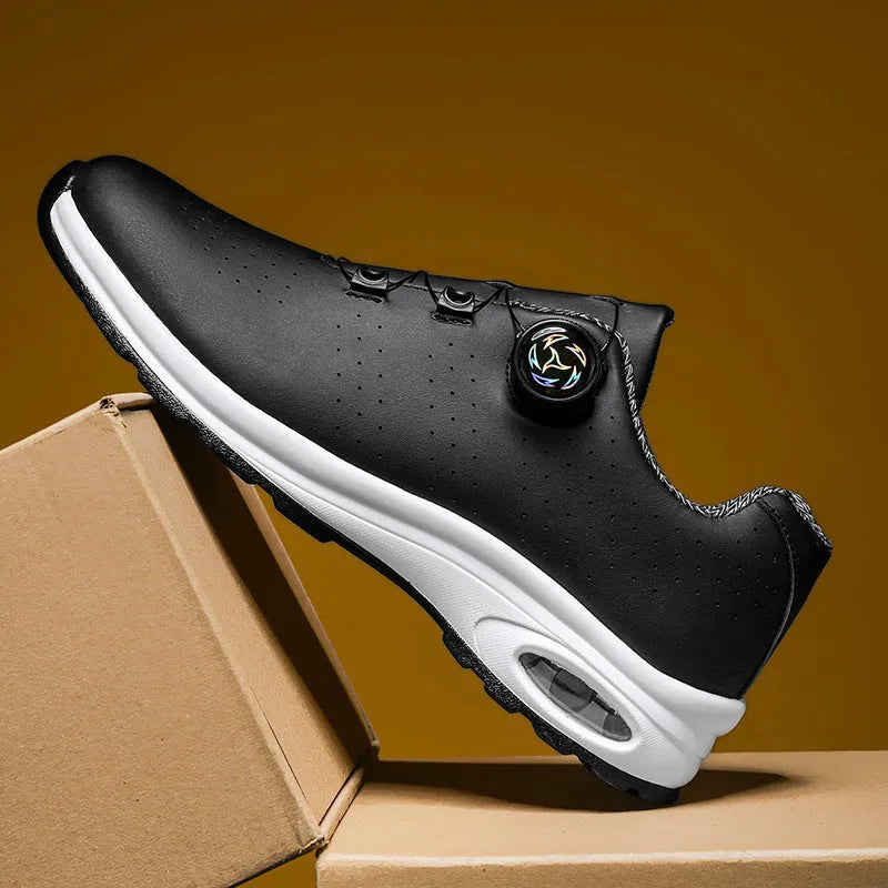 Black and white low top casual tennis shoes with cross shoulder straps and mesh upper.