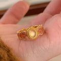 Open mouth geometric ring with pink crystal enamel accents on gold-plated copper band