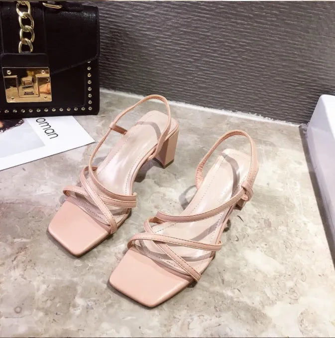 Women's white thick heel slip-on Roman sandals with a side air design on a rubber sole.