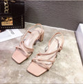 Women's white thick heel slip-on Roman sandals with a side air design on a rubber sole.