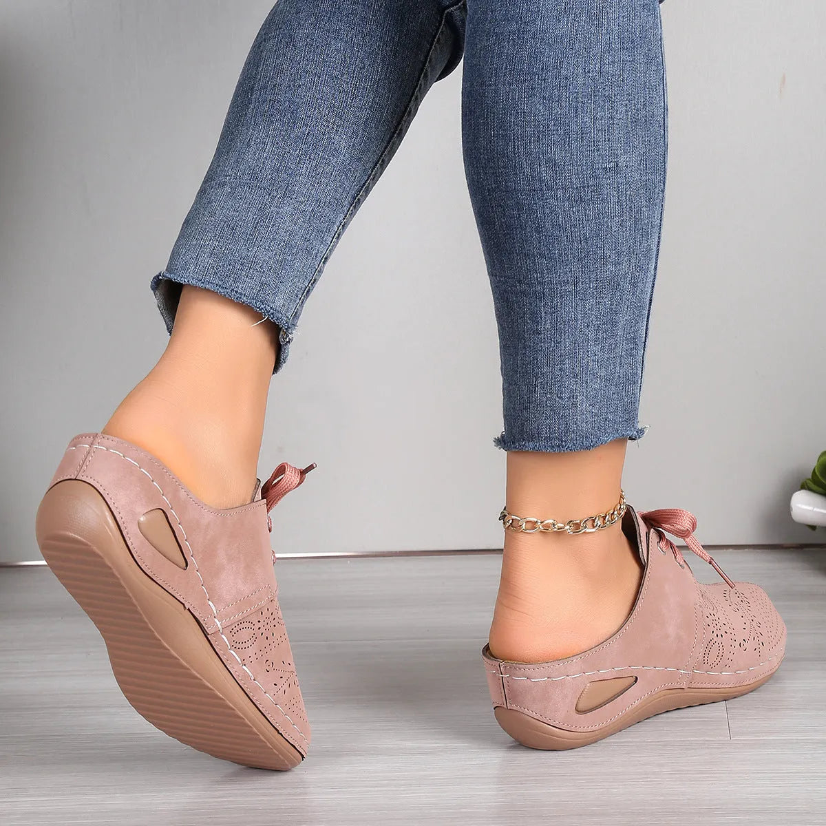 Women's black suede lace-up wedge slippers with hollow-out design and rubber sole.