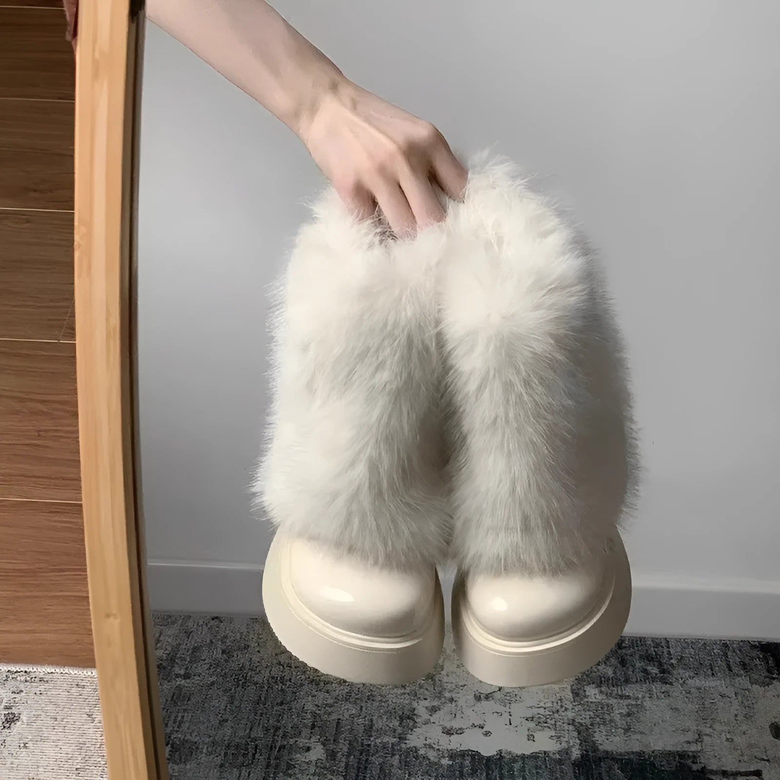 Black low-top snow boot with plush material and a waterproof rubber platform sole.